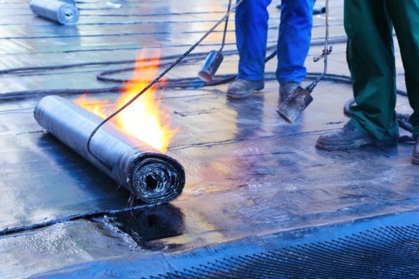 men Crout roof with hot tar